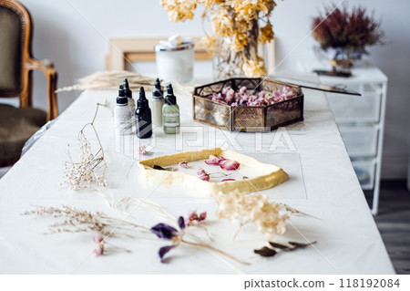 Dried flower crafting setup on a table with resin mold and pigments. Natural decor, floral art, DIY home decoration, sustainable crafts, interior styling. 118192084