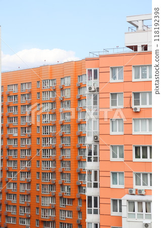 The facade of a tall building is finished with red brick, urban background, Moscow region The facade of a tall building is finished with red brick, urban background, Moscow region 118192398
