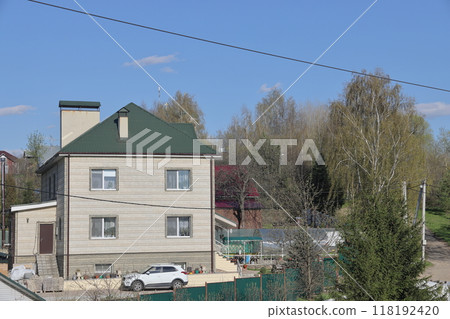 Garden plot next to a country house, soil prepared for planting, suburb of a big city. Garden plot next to a country house, soil prepared for planting, suburb of a big city. 118192420