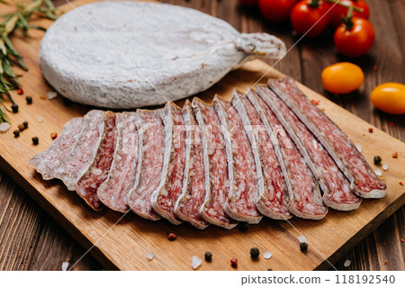 Close-up of sliced dry-cured salami on board, ideal for gourmet food and charcuterie presentations Close-up of sliced dry-cured salami on board, ideal for gourmet food and charcuterie presentations 118192540