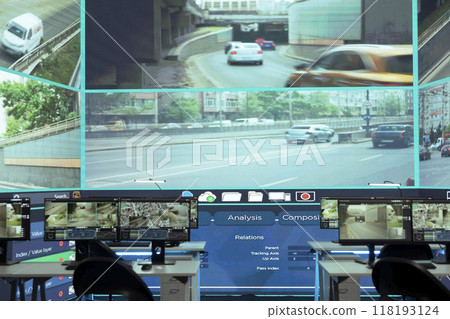 Empty monitoring room full of workstations used to observe traffic surveillance footage on CCTV security cameras around the city. Agency using government satellite radar for public safety. Empty monitoring room full of workstations used to observe traffic surveillance footage on CCTV security cameras around the city. Agency using government satellite radar for public safety. 118193124