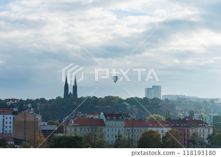 Hot air balloon flying over the city Prague at sunset background. Hot air balloon flying over the city Prague at sunset background. 118193180