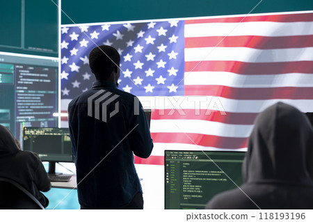 A technical team in a governmental cyber environment with the USA flag. Focus on cybersecurity strategy, threat management and secure operations for national security and digital defense. 118193196