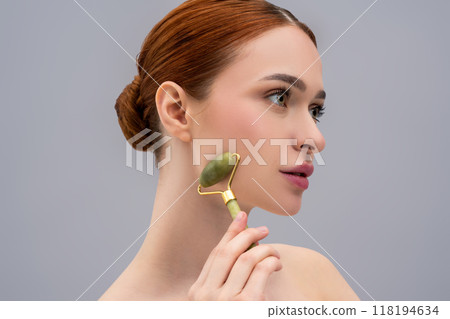 Young attractive female using facial massager for skin care Young attractive female using facial massager for skin care 118194634