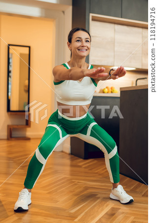 Energetic woman enjoying her aerobic exercises 118194716