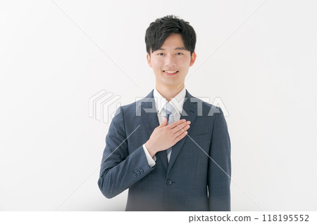 A man in a suit with his hand on his chest 118195552