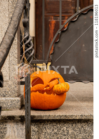 Exterior Beautiful atmospheric halloween carved pumpkins decorated on porch. Autumn leaves and fall flowers celebration holiday Thanksgiving October season Exterior Beautiful atmospheric halloween carved pumpkins decorated on porch. Autumn leaves and fall flowers celebration holiday Thanksgiving October season 118196013