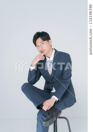 Man in suit sitting on chair Man in suit sitting on chair 118196396