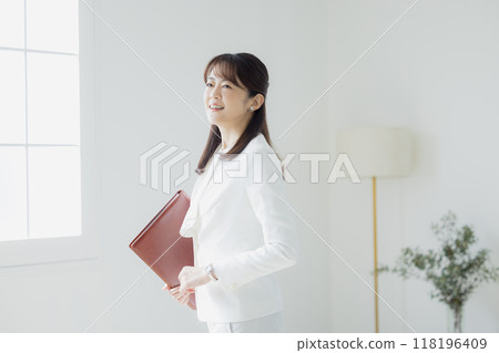 Woman in a white suit 118196409