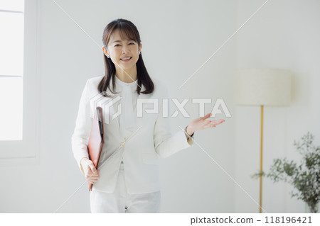 Woman in a white suit 118196421