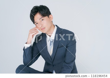 Man in suit sitting on chair Man in suit sitting on chair 118196454