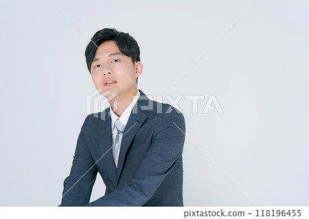 Man in suit sitting on chair Man in suit sitting on chair 118196455
