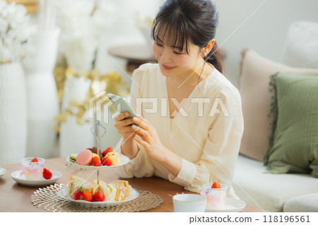 A woman eating sweets at a cafe A woman eating sweets at a cafe 118196561