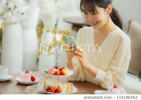 A woman eating sweets at a cafe A woman eating sweets at a cafe 118196562