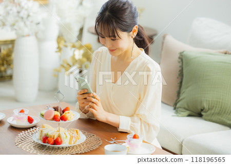 A woman eating sweets at a cafe A woman eating sweets at a cafe 118196565