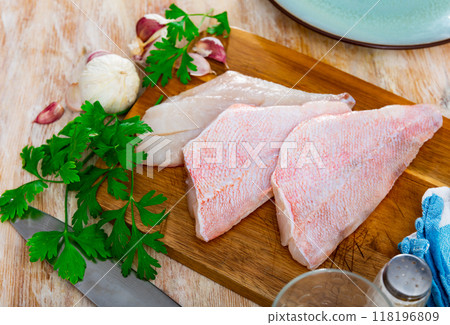 Unprepared chicken fillets on kitchen table Unprepared chicken fillets on kitchen table 118196809