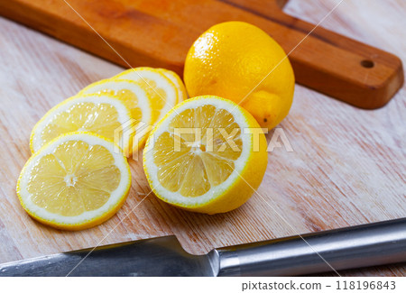 Lemon and knife on cutting board Lemon and knife on cutting board 118196843
