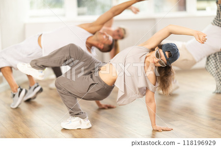 Young girl practicing breakdance in training hall Young girl practicing breakdance in training hall 118196929