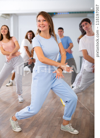 Group of different people rehearsing dance in dance studio 118197007