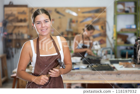 Girl is busy in carpentry workshop Girl is busy in carpentry workshop 118197032