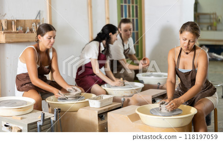 Girl working with pottery wheel Girl working with pottery wheel 118197059