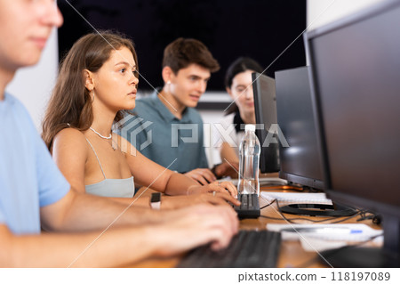 Focused young female software developer working in IT startup 118197089