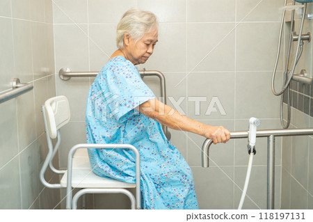 Asian elderly woman patient use toilet bathroom handle security in nursing hospital, healthy strong medical concept. Asian elderly woman patient use toilet bathroom handle security in nursing hospital, healthy strong medical concept. 118197131