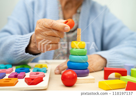 Alzheimer disease AD, Asian elderly woman patient suffering from dementia learn practical motor skills rehabilitation. 118197137