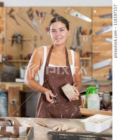 Girl is busy in carpentry workshop 118197157