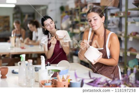 Girl performs polishing of ceramic product 118197258