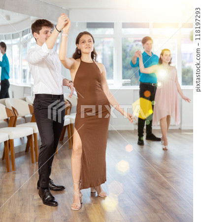 Happy girls paired with guys dance waltz in dance studio 118197293