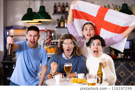 Company of young adult emotional fans supporting English team with state flag while resting in sports bar with beer Company of young adult emotional fans supporting English team with state flag while resting in sports bar with beer 118197299
