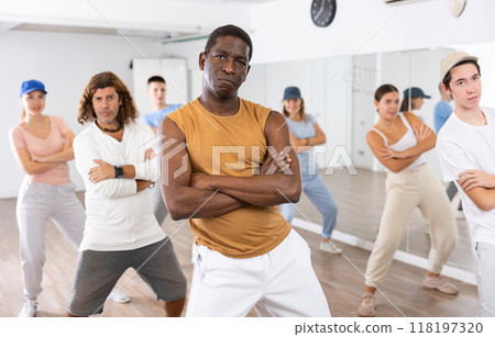 Happy multiracial men women of different ages performing dynamic energetic dancing movements in modern loft studio 118197320