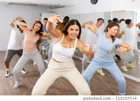 Group of different people rehearsing dance in dance studio Group of different people rehearsing dance in dance studio 118197514