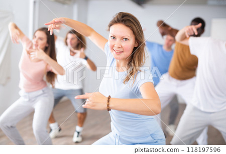 Adult woman learning dance in dance studio 118197596