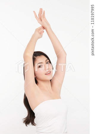 Beautiful Young Asian woman lifting hands up to show off clean and hygienic armpits or underarms on white background, Smooth armpit cleanliness and protection concept 118197995