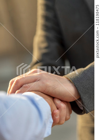 Vertical Businessman shaking hands together team partnership teamwork. Trust honesty business customer handshake together promise respect partner. Vertical Horizon Businessman solidarity team Partner Vertical Businessman shaking hands together team partnership teamwork. Trust honesty business customer handshake together promise respect partner. Vertical Horizon Businessman solidarity team Partner 118198475