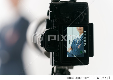 A man in a suit taking a photo 118198541