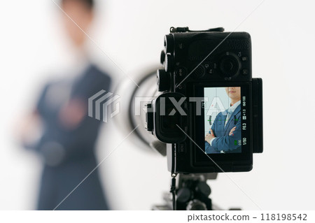 A man in a suit taking a photo 118198542
