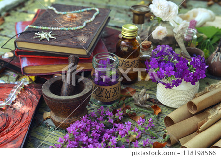Mystic still life with witchy bottles, magic books of spells and ritual objects on old table. Occult, esoteric, wicca and divination concept. No foreign language, all symbols are fictional 118198566