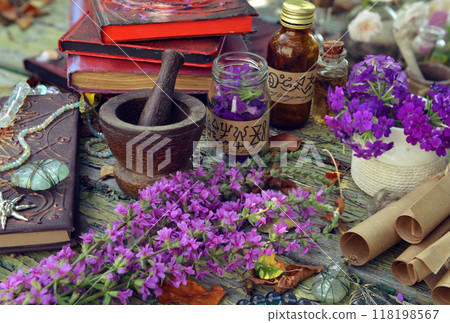 Mystic still life with old books, witchy bottles and ritual objects on old table. Occult, esoteric, wicca and divination concept. No foreign language, all symbols are fictional Mystic still life with old books, witchy bottles and ritual objects on old table. Occult, esoteric, wicca and divination concept. No foreign language, all symbols are fictional 118198567