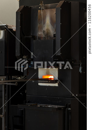 Black furnace is in a glass blowing workshop Black furnace is in a glass blowing workshop 118200456