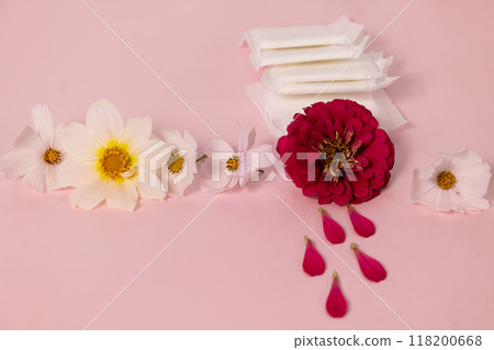flowers and sanitary pads beautifully arranged on a pink background, aesthetics of menstruation flowers and sanitary pads beautifully arranged on a pink background, aesthetics of menstruation 118200668