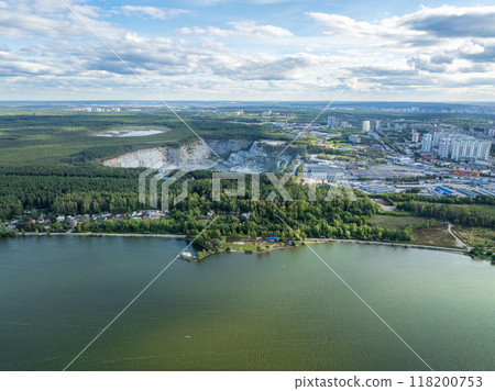 Stone quarry in the forest. Flying over the summer mixed forest during sunset. The surroundings of Yekaterinburg. Ural, Russia, Aerial View 118200753