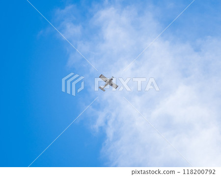 Small ultralight airplane with overhead wing and single propeller flying in sunset sky. Small ultralight airplane with overhead wing and single propeller flying in sunset sky. 118200792