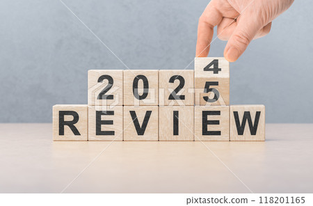 2025 review new year. hand turns wooden cube and changes number Review 2024 to Review 2025. Business, 2025 review new year concept. gray background, copy space. 2025 review new year. hand turns wooden cube and changes number Review 2024 to Review 2025. Business, 2025 review new year concept. gray background, copy space. 118201165