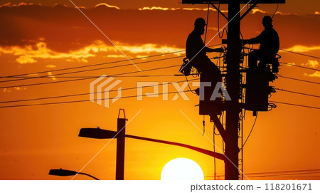 Dedicated effort - men working on electricity pole, skilled workers repairing breakdown in electricity supply, restoring essential power to community, labour day with hard work and commitment. 118201671
