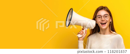 Dynamic announcement - smiling young woman with megaphone promoting sale offers on single colour background, ideal for banner design or with space for text, emphasizing enthusiasm and engagement Dynamic announcement - smiling young woman with megaphone promoting sale offers on single colour background, ideal for banner design or with space for text, emphasizing enthusiasm and engagement 118201837