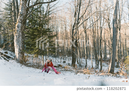 Girl playing snowballs in the winter forest 118202871