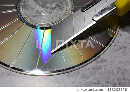 A CD with radial scratches made with a cutter 118203558